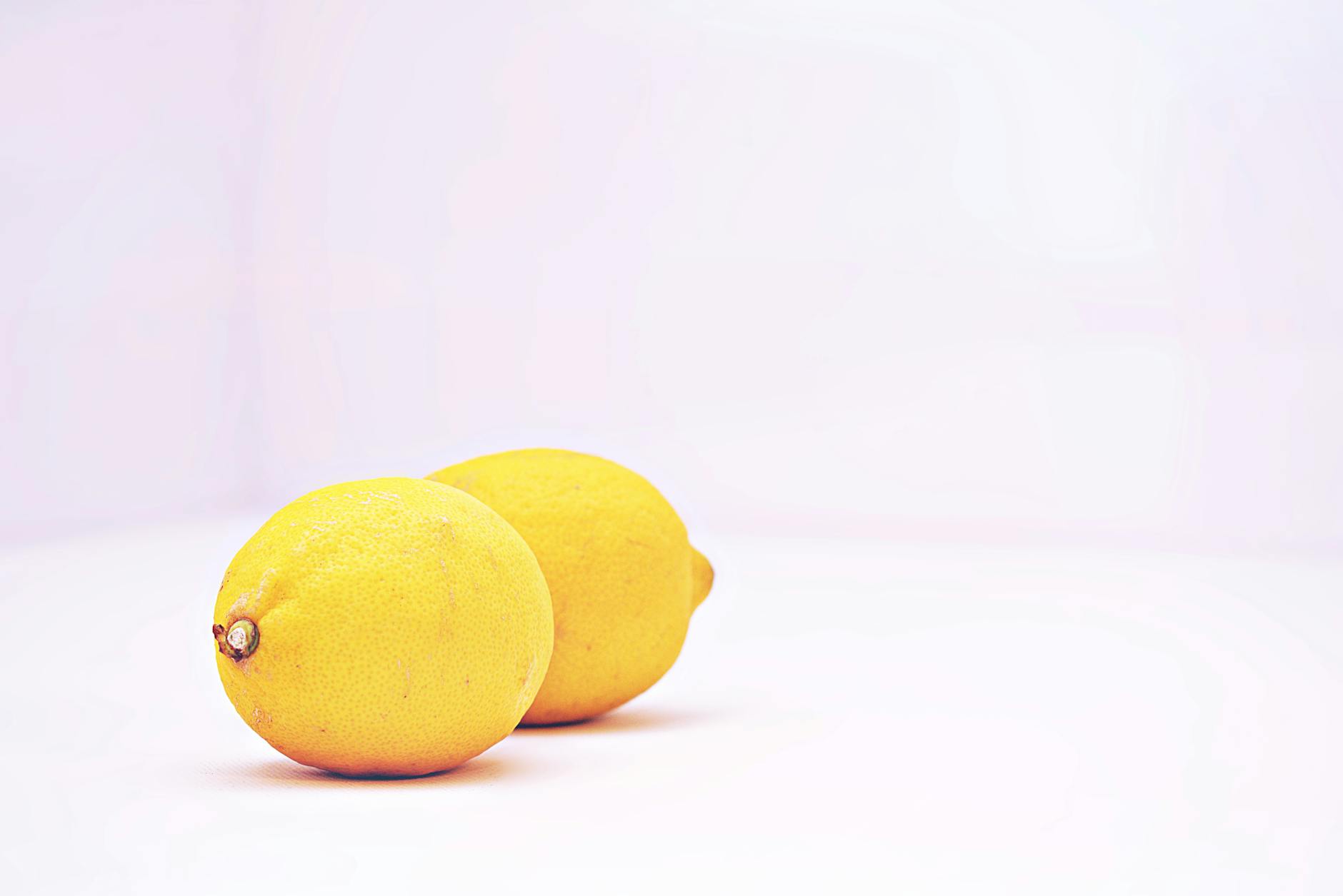Two fresh lemons on a white background, symbolizing a fresh start