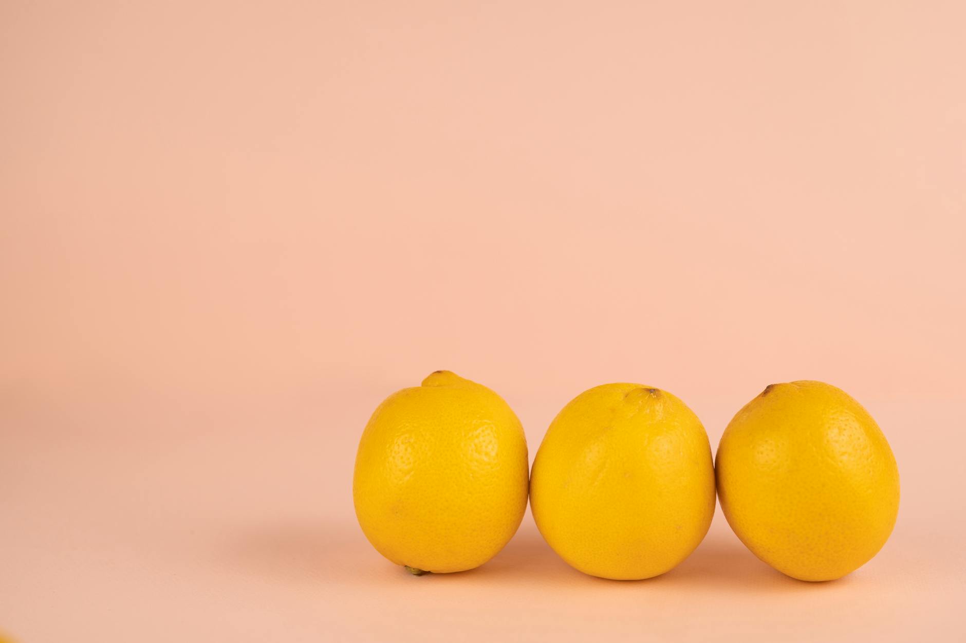 Bright ripe lemons arranged on a pastel background, symbolizing the shift in sensory experience
